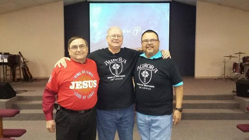 Charley (center) with two friends at the front of the church sanctuary